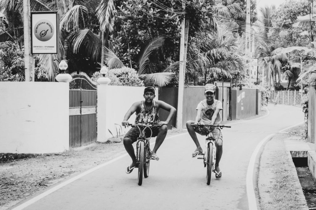 Young men out and about on their bicycles in Mirissa - Sri Lanka.